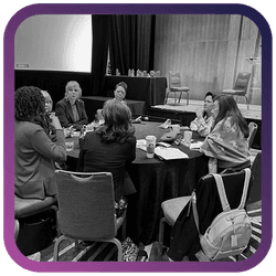 Image of women sitting at a round table