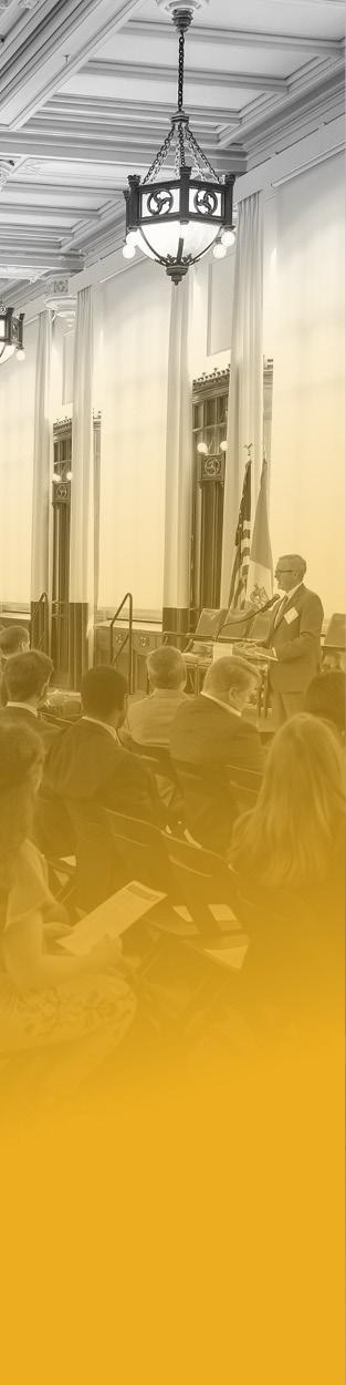 People in chairs listening to a conference speaker