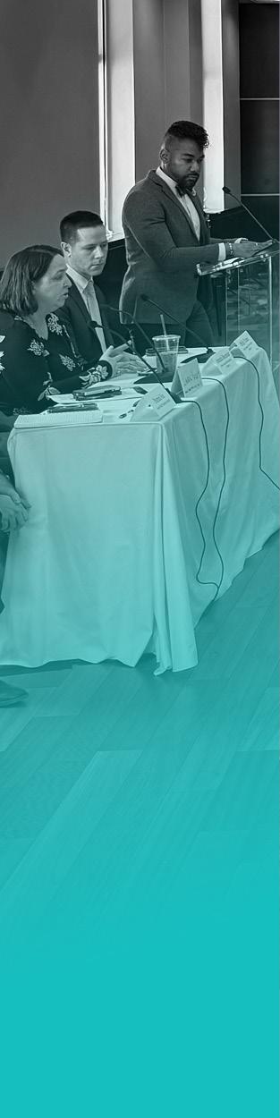 Image of people speaking at a conference